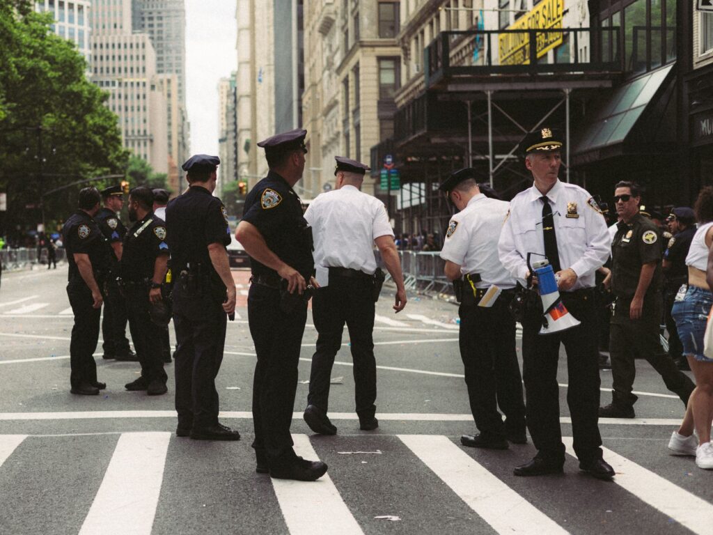 Police officers ensuring public safety at a city street during an urban event or parade.
