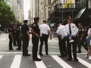 Police officers ensuring public safety at a city street during an urban event or parade.